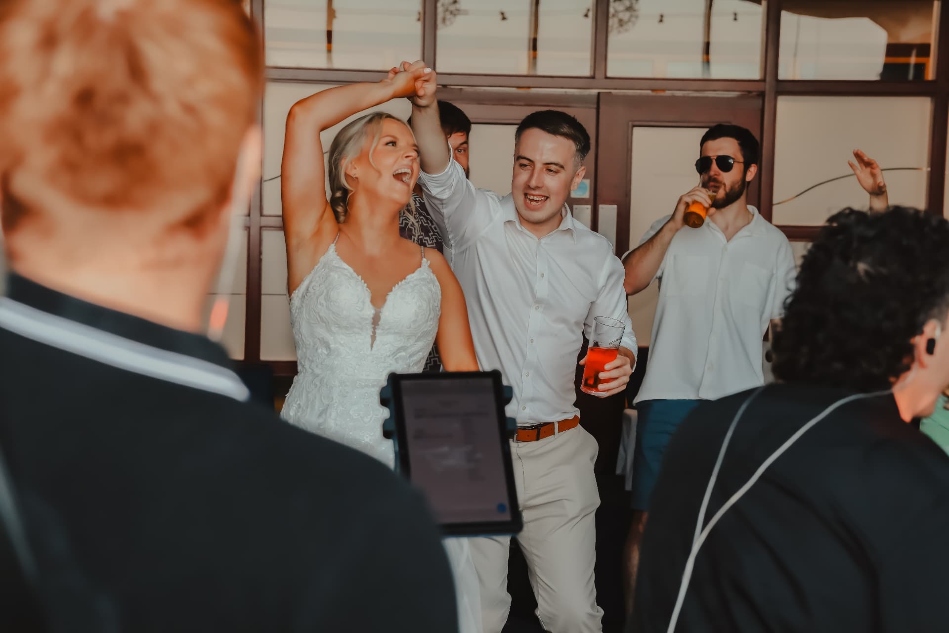 Bride singing and dancing with guests during a lively reception