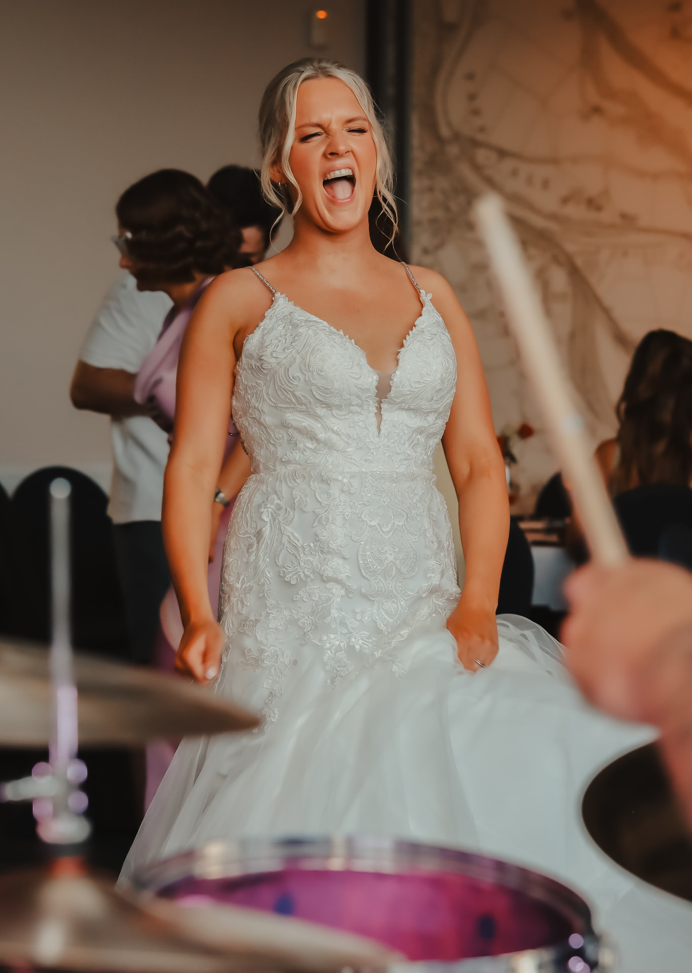 Bride singing with abandon on the dance floor beside a live band